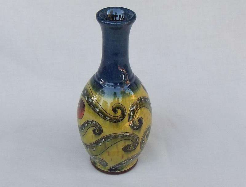 A signed vintage handmade pottery vase with octopus motif