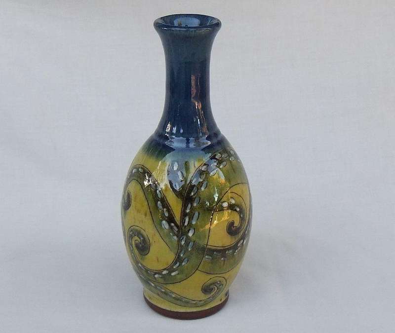 A signed vintage handmade pottery vase with octopus motif