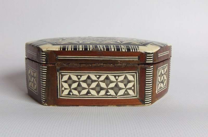 A vintage six sided hand made jewelry box with mother of pearl and bone inlay