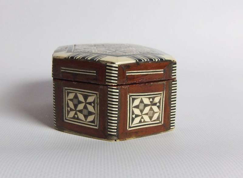 A vintage six sided hand made jewelry box with mother of pearl and bone inlay