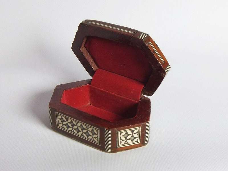 A vintage six sided hand made jewelry box with mother of pearl and bone inlay