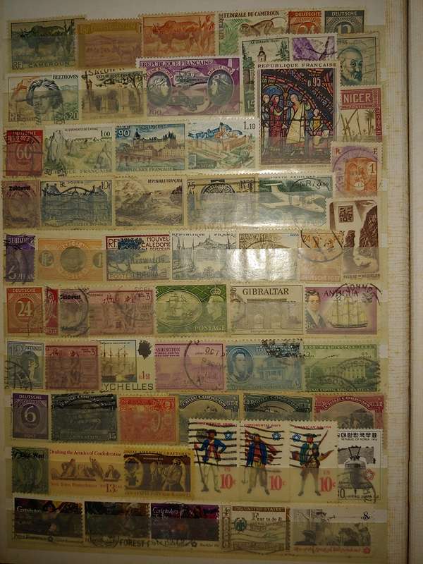 USED A4 STOCKBOOK 16/32 PAGES LOADED WITH WORLD STAMPS WRITING ON PAGES STAMPS GOOD VALUE