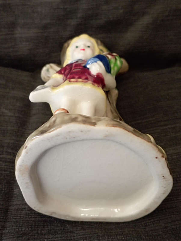 A beautiful vintage colourful vase..little girl standing by tree trunk