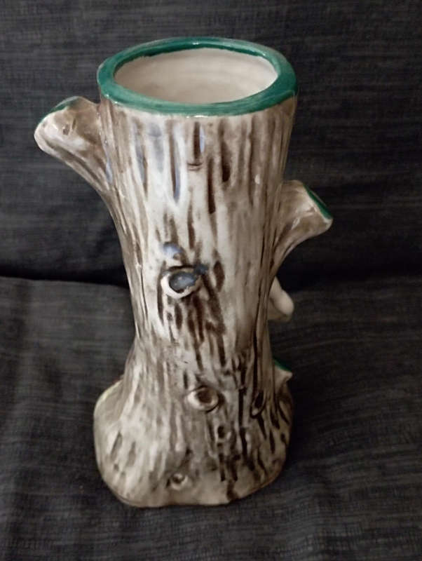 A beautiful vintage colourful vase..little girl standing by tree trunk