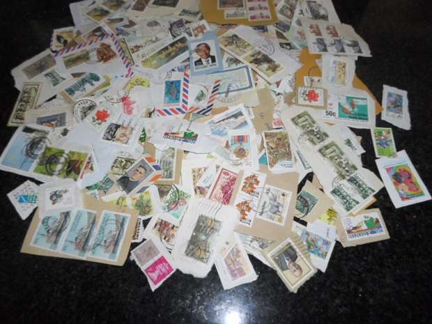 500 X USED STAMPS ON PAPER SEE PICS