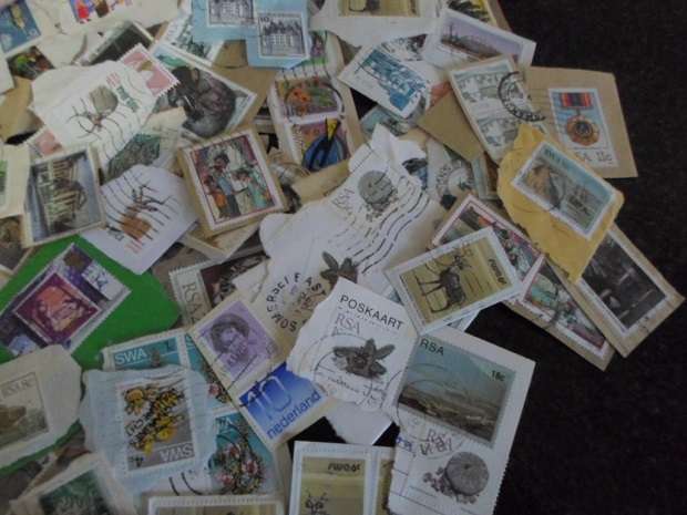 500 X USED STAMPS ON PAPER SEE PICS