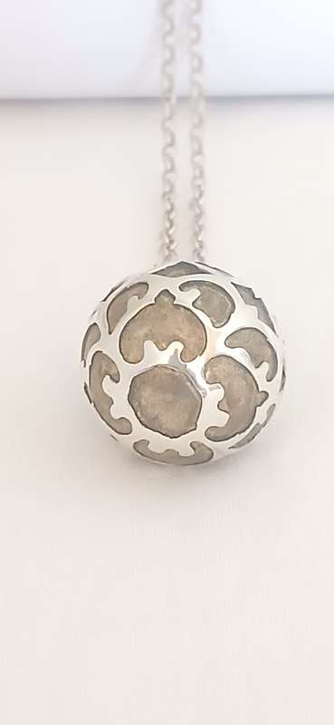 Sterling silver pendant with brass chime on chain