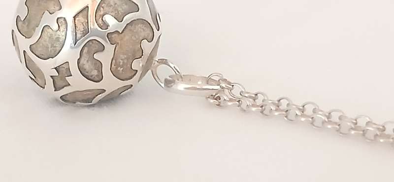 Sterling silver pendant with brass chime on chain
