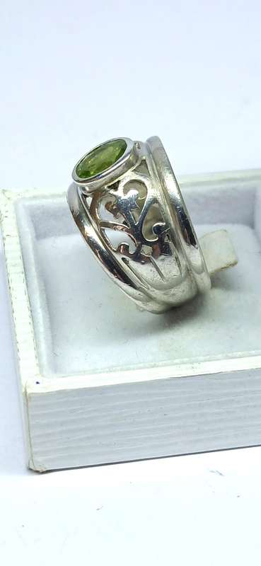 Sterling silver broad ring with green stone