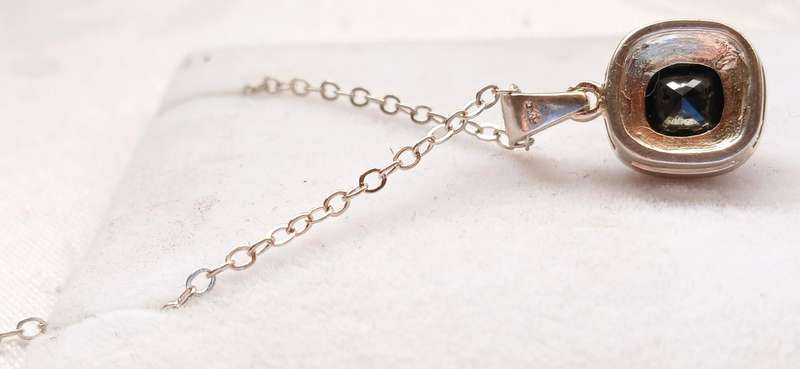 Sterling silver pendant with black stone on chain