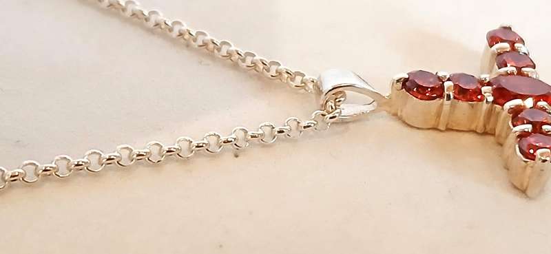 Sterling silver cross pendant with orange stones on chain