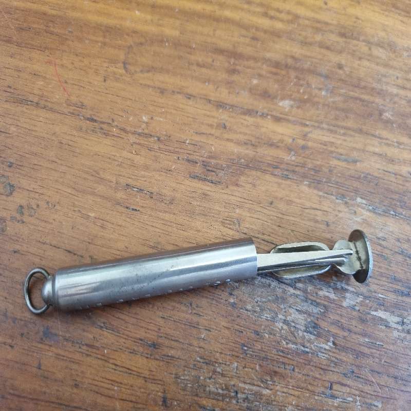 Vintage Metal Foldable Pipe Tool in container saying: Use Cooper's dip