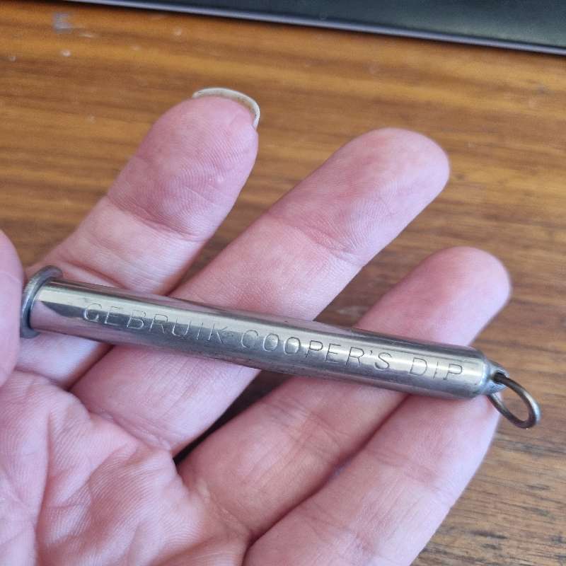 Vintage Metal Foldable Pipe Tool in container saying: Use Cooper's dip