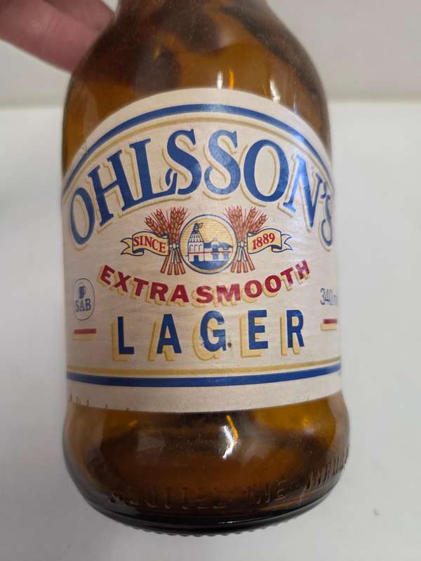 Vintage Ohlsson's Lager bottle with cap