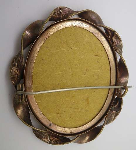 Large Antique Victorian photo memorial brooch with twisted scroll rim. Pinchbeck or gold plated?