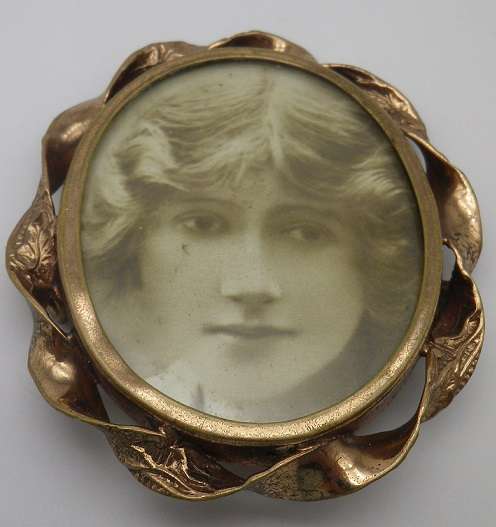 Large Antique Victorian photo memorial brooch with twisted scroll rim. Pinchbeck or gold plated?