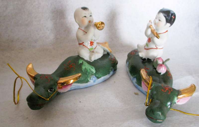 SALE R25 - Two Cute Ceramic Chinese Musical Babies on lying cows Figurenes. 170x100mm