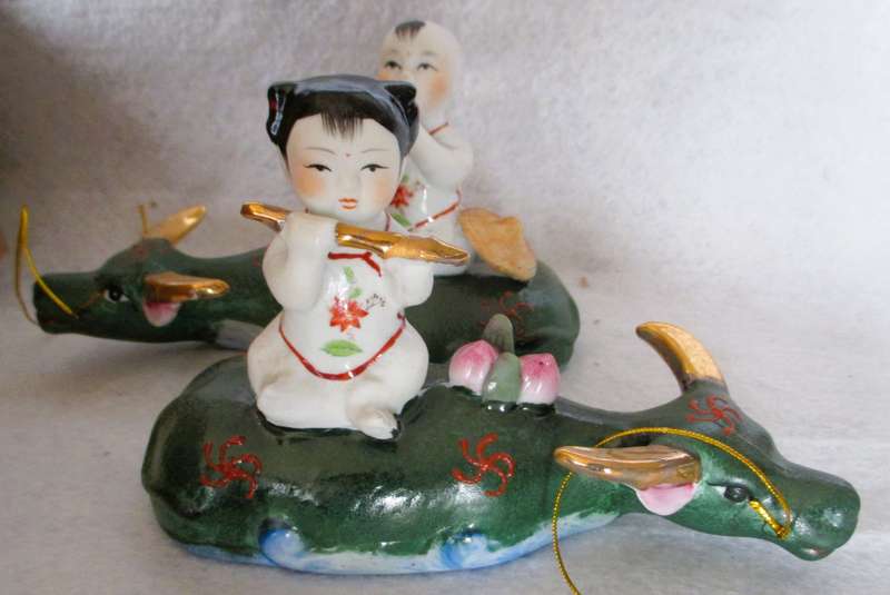 SALE R25 - Two Cute Ceramic Chinese Musical Babies on lying cows Figurenes. 170x100mm