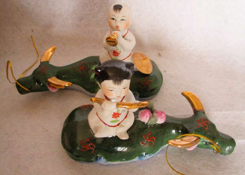 SALE R25 - Two Cute Ceramic Chinese Musical Babies on lying cows Figurenes. 170x100mm