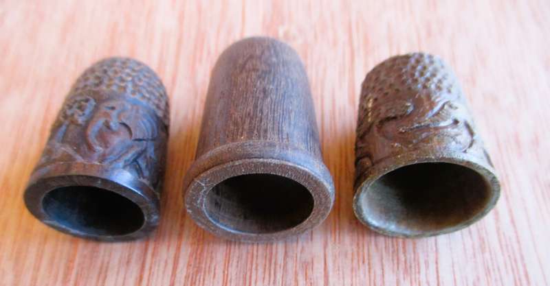 Lot of three wooden thimbles, 2 with elephants carved, different sizes.