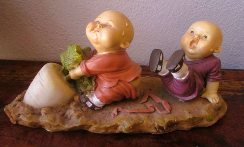 Vintage Shaolin Baby Monk Resin Figurene pulling a Diakon Radish. Very Collectable. 180x85mm
