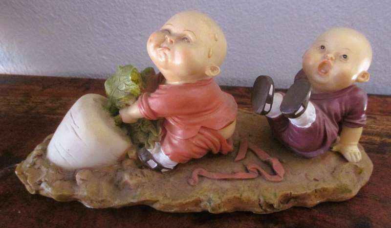 Vintage Shaolin Baby Monk Resin Figurene pulling a Diakon Radish. Very Collectable. 180x85mm