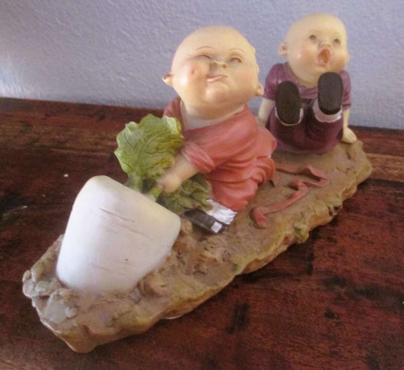 Vintage Shaolin Baby Monk Resin Figurene pulling a Diakon Radish. Very Collectable. 180x85mm