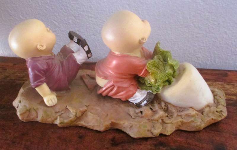 Vintage Shaolin Baby Monk Resin Figurene pulling a Diakon Radish. Very Collectable. 180x85mm