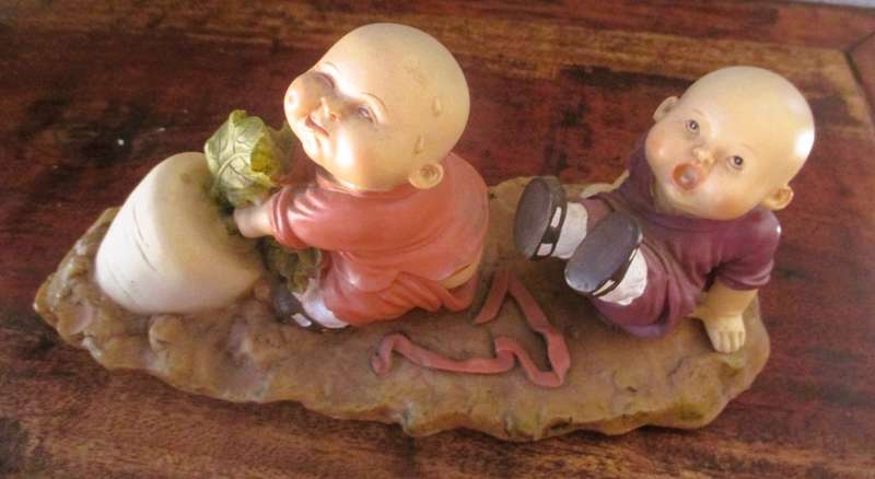 Vintage Shaolin Baby Monk Resin Figurene pulling a Diakon Radish. Very Collectable. 180x85mm