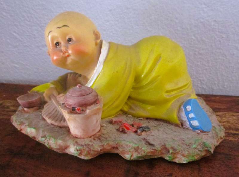 Vintage Shaolin Baby Monk Resin Figurene making a fire. Very Collectable. 140x100mm