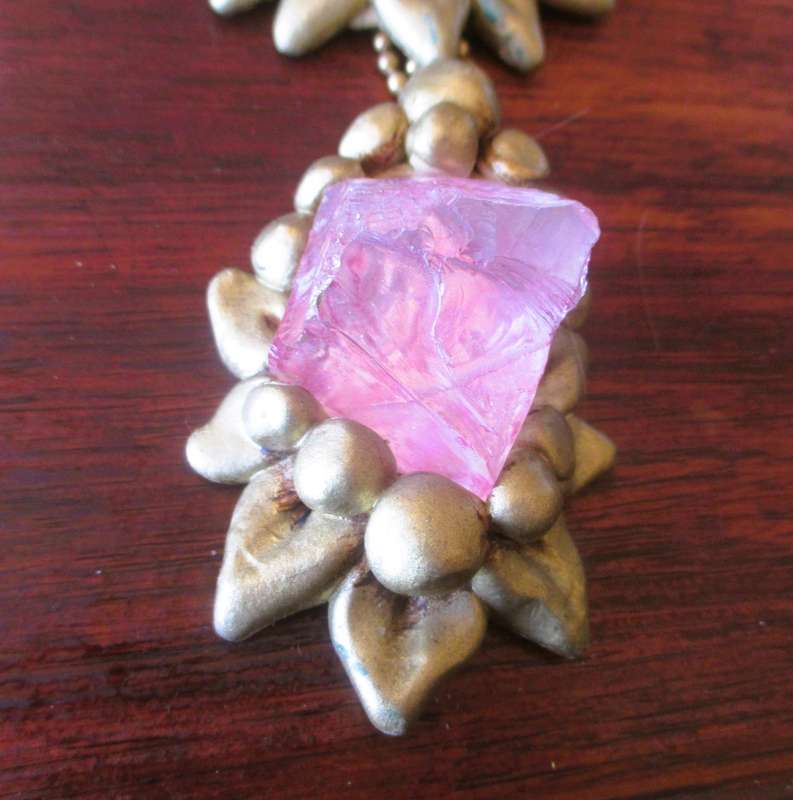 Bulky stage clay jewelry with large pink centre.