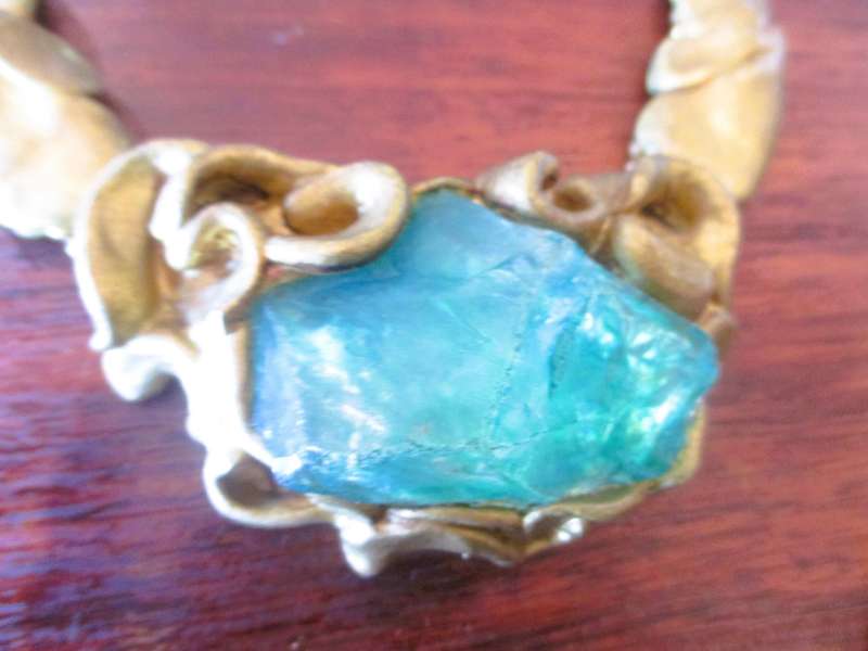 Bulky stage clay jewelry with large blue centre.