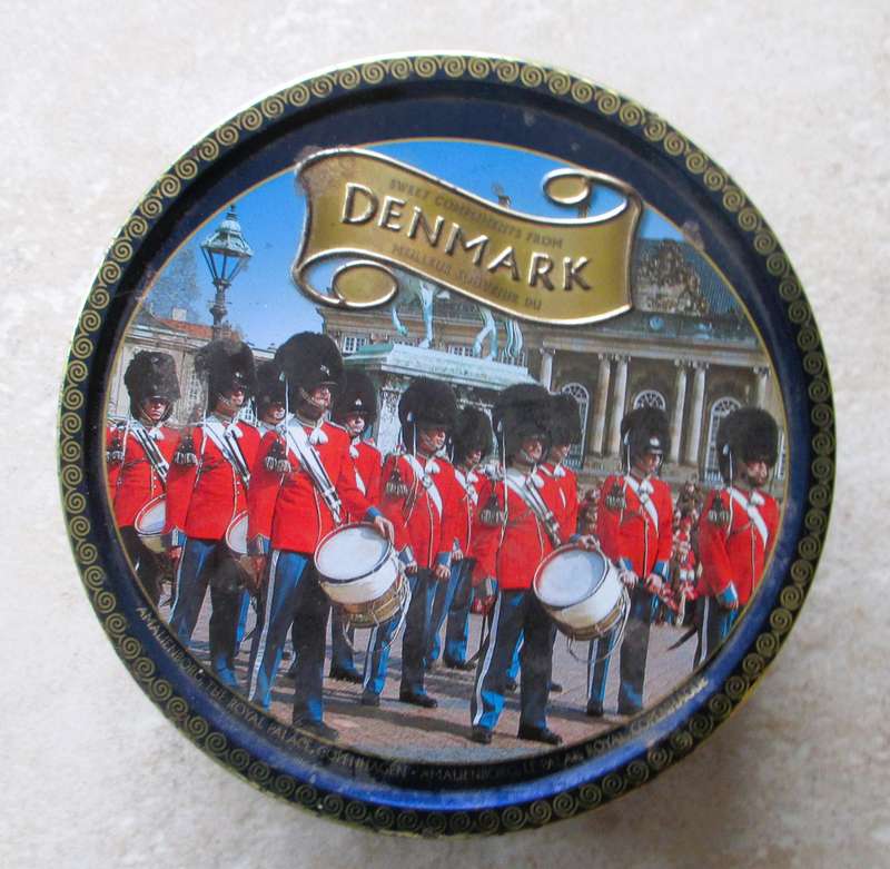 Vintage enmark Cookie Tin withlots of balck and white photos.