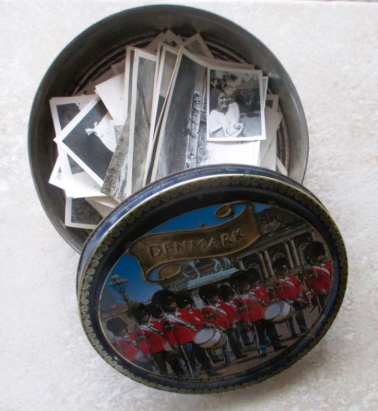 Vintage enmark Cookie Tin withlots of balck and white photos.