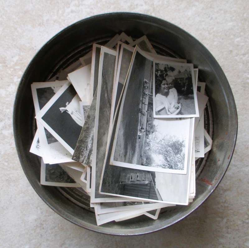Vintage enmark Cookie Tin withlots of balck and white photos.