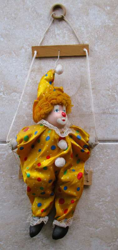 Vintage Hanging Porcelain Face Clown Doll with Yellow Hair, clothes on a swing. Doll 400mm long