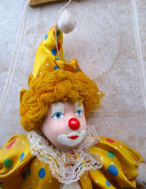Vintage Hanging Porcelain Face Clown Doll with Yellow Hair, clothes on a swing. Doll 400mm long