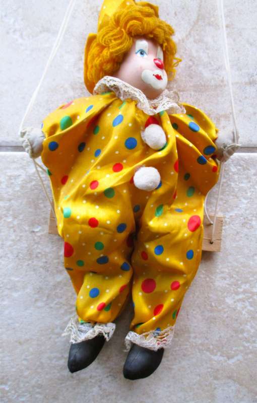Vintage Hanging Porcelain Face Clown Doll with Yellow Hair, clothes on a swing. Doll 400mm long