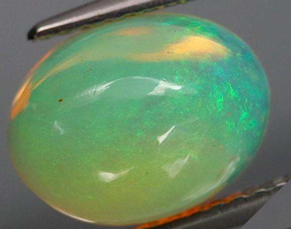 2.29Ct.Opal Oval Cab. Yellow & Rainbow Color Sparkling  Ethiopia