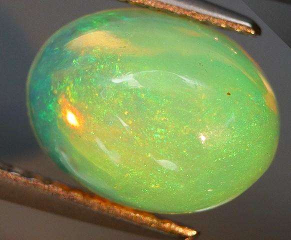 2.29Ct.Opal Oval Cab. Yellow & Rainbow Color Sparkling  Ethiopia