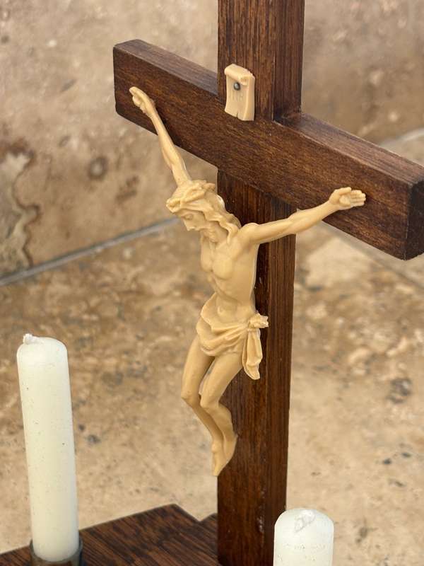 Vintage wooden crucifix with candles
