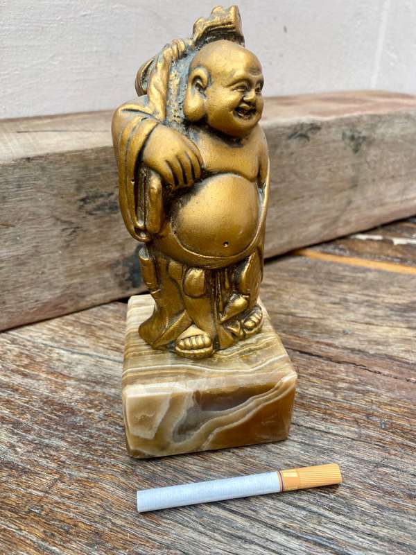 Buddha figure on petrified wood base pedestal