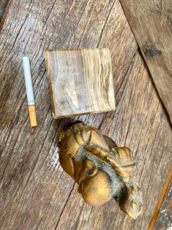 Buddha figure on petrified wood base pedestal