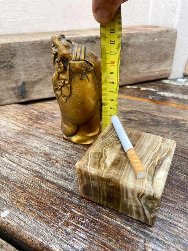 Buddha figure on petrified wood base pedestal