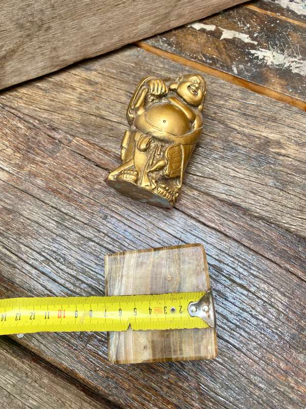 Buddha figure on petrified wood base pedestal