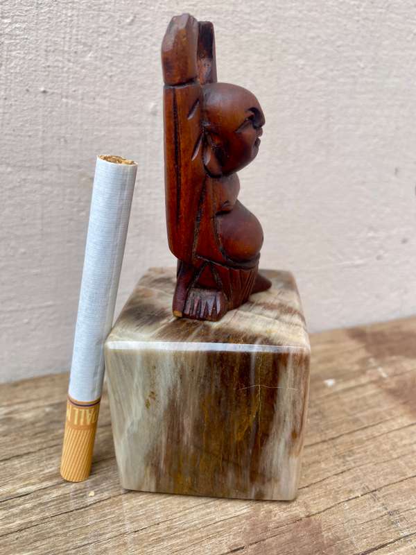 Small wood Buddha figure on petrified wood base pedestal cube