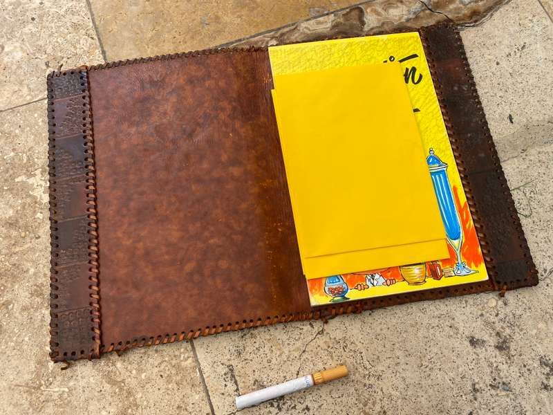 Vintage leather journal cover with prescription notes and envelopes