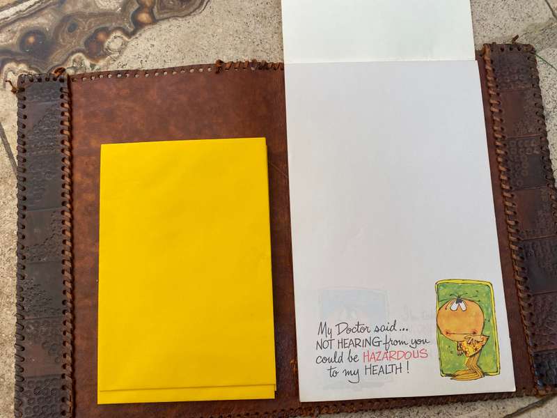 Vintage leather journal cover with prescription notes and envelopes