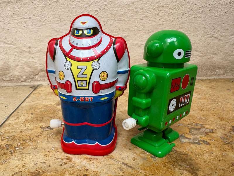 Retro tin Schylling Rowley wind up tin robot , pvc green wind up robot pair