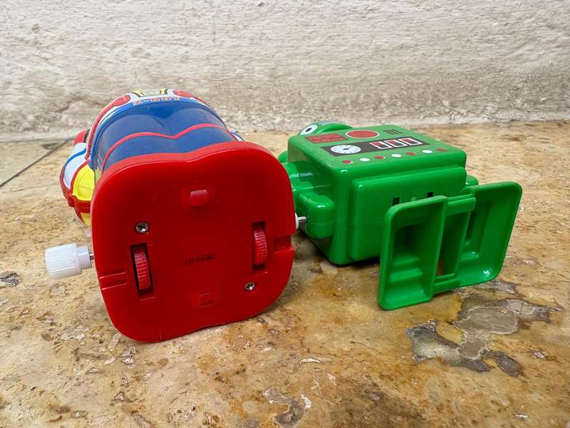 Retro tin Schylling Rowley wind up tin robot , pvc green wind up robot pair